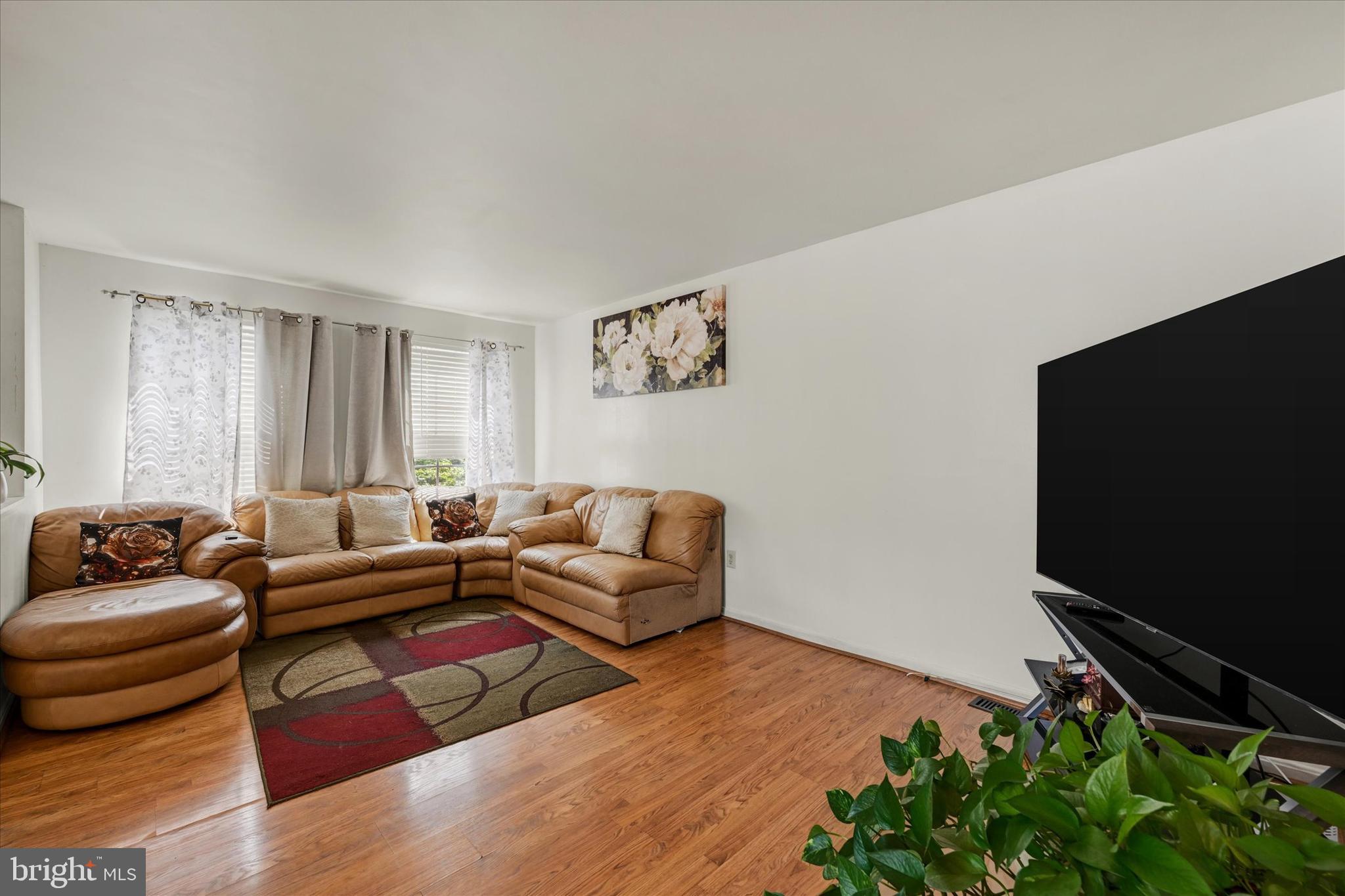 2838 Pennsylvania Avenue Baltimore, MD 21227 - Photo 6 of 32 a living room with furniture and a flat screen tv