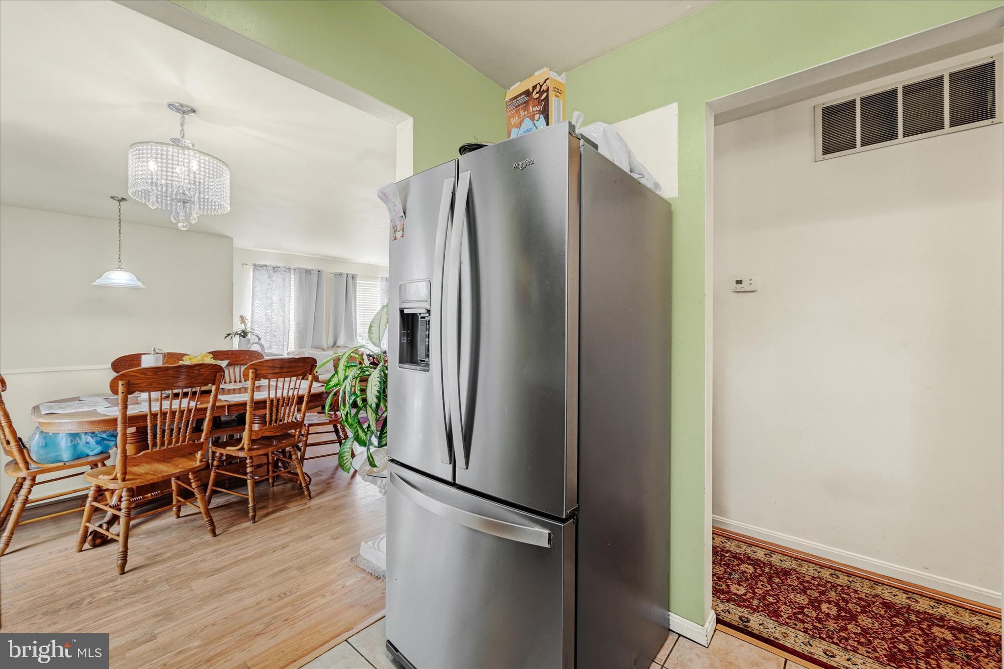 2838 Pennsylvania Avenue Baltimore, MD 21227 - Photo 9 of 32 a kitchen with stainless steel appliances a refrigerator and a wooden floor