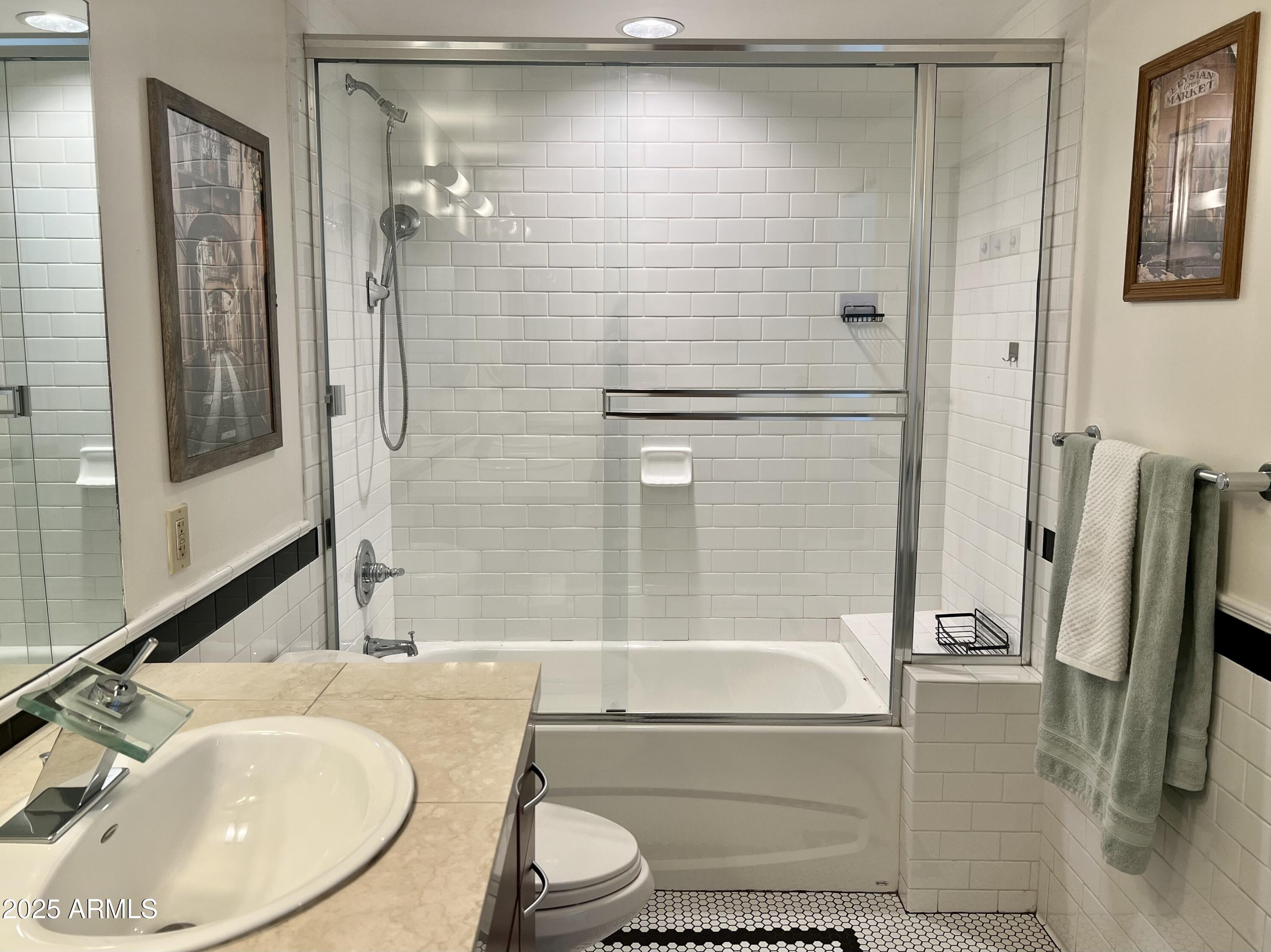 114 West Adams Street, Unit 1007 Phoenix, AZ 85003 - Photo 27 of 63 a bathroom with a sink and a mirror