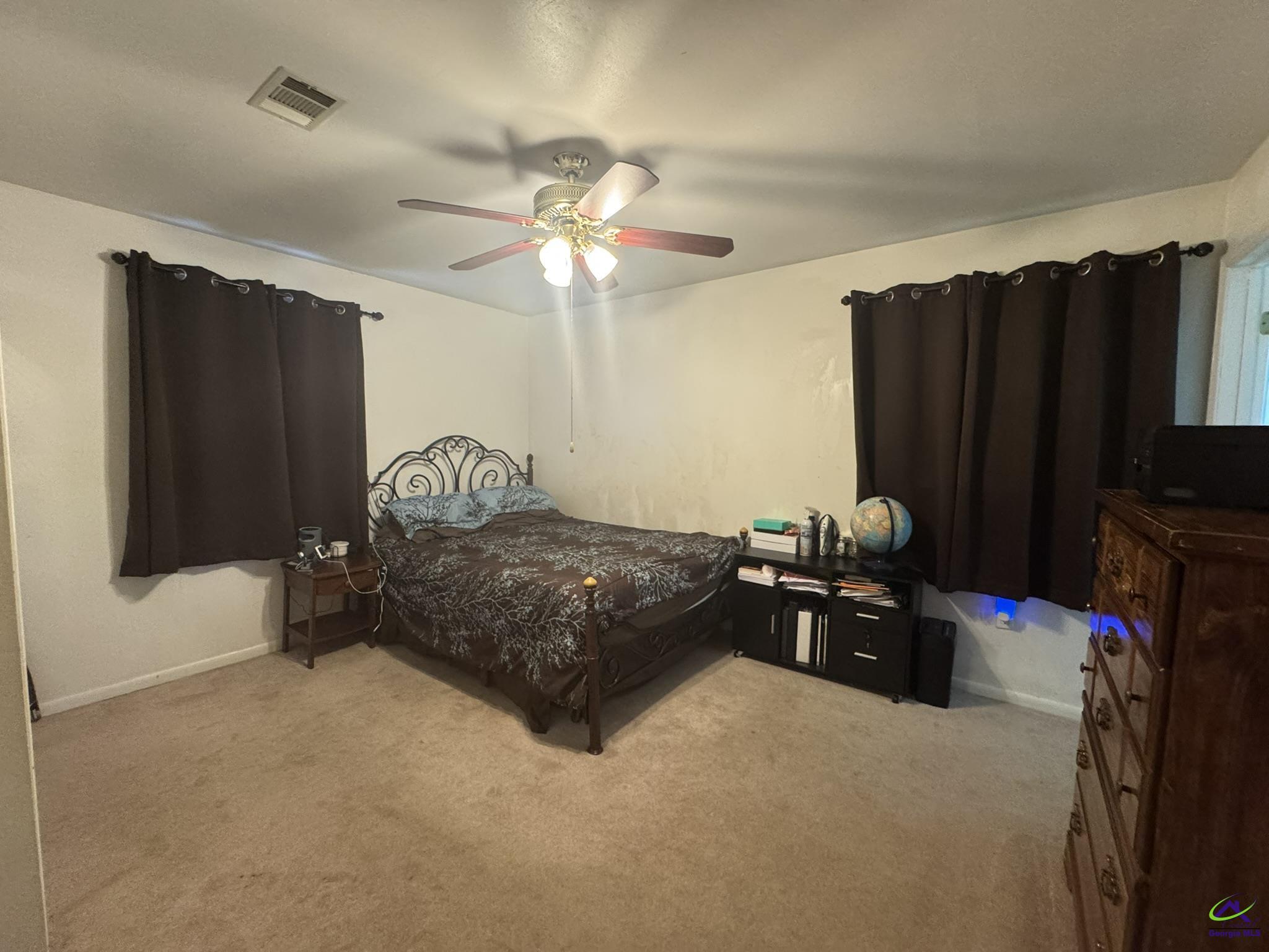 1032 Elberta Road Warner Robins, GA 31093 - Photo 14 of 26 a bedroom with a bed dresser and a flat tv screen