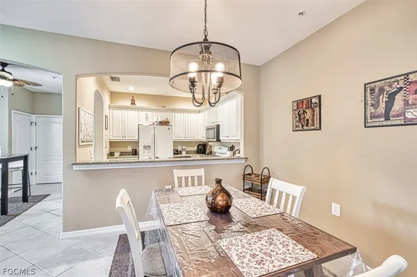 a kitchen with a dining table and cabinets