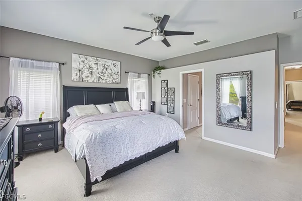 a bedroom with a large bed and a chandelier