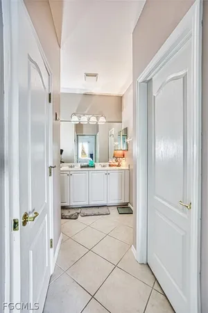 a kitchen with kitchen island white cabinets and refrigerator