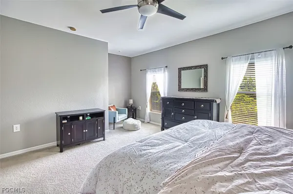 a bedroom with a large bed and a dresser