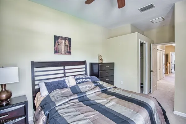 a bedroom with a bed and a lamp