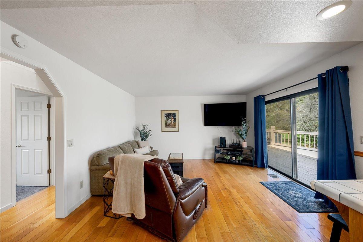 13936 Oak Ridge Road Penn Valley, CA 95946 - Photo 24 of 83 a living room with furniture a flat screen tv and a large window