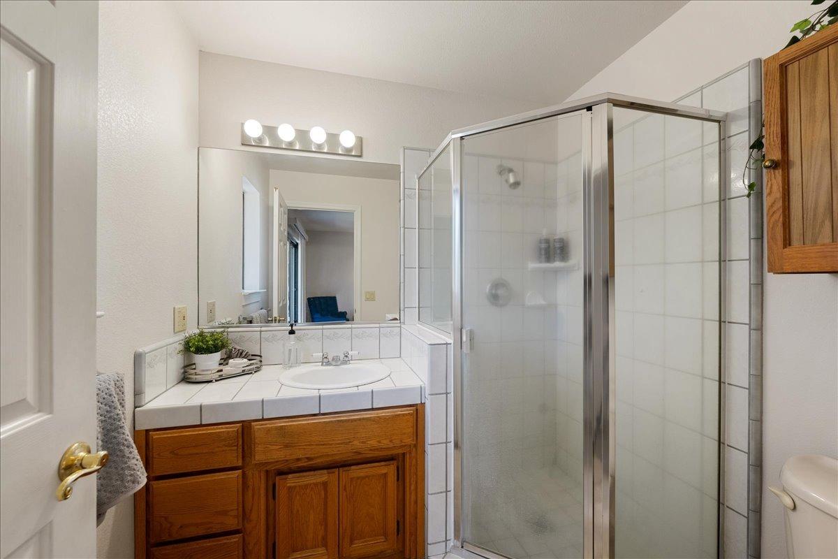 13936 Oak Ridge Road Penn Valley, CA 95946 - Photo 30 of 83 a bathroom with a sink shower and a mirror
