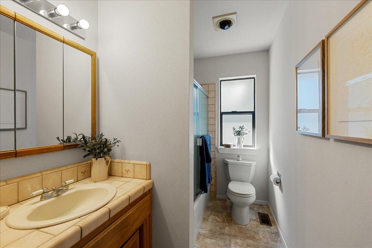 13936 Oak Ridge Road Penn Valley, CA 95946 - Photo 34 of 83 a bathroom with a sink a toilet and a mirror