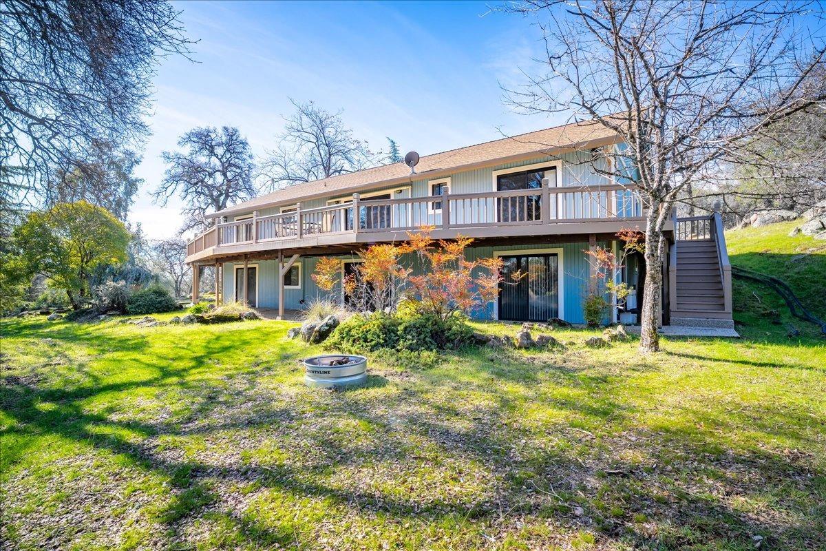 13936 Oak Ridge Road Penn Valley, CA 95946 - Photo 52 of 83 a front view of a house with a yard table and chairs