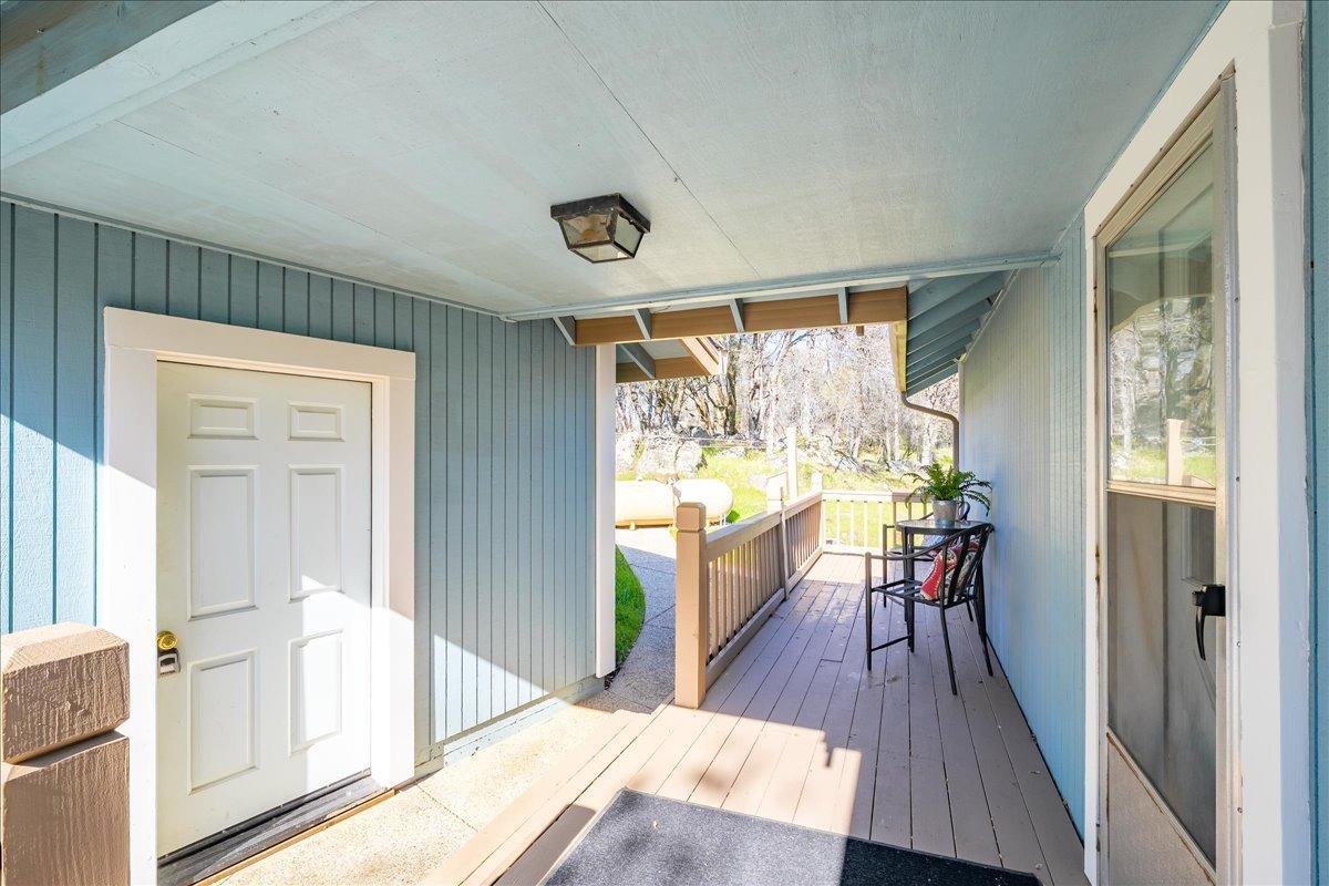 13936 Oak Ridge Road Penn Valley, CA 95946 - Photo 10 of 83 a view of a hallway with wooden floor and furniture