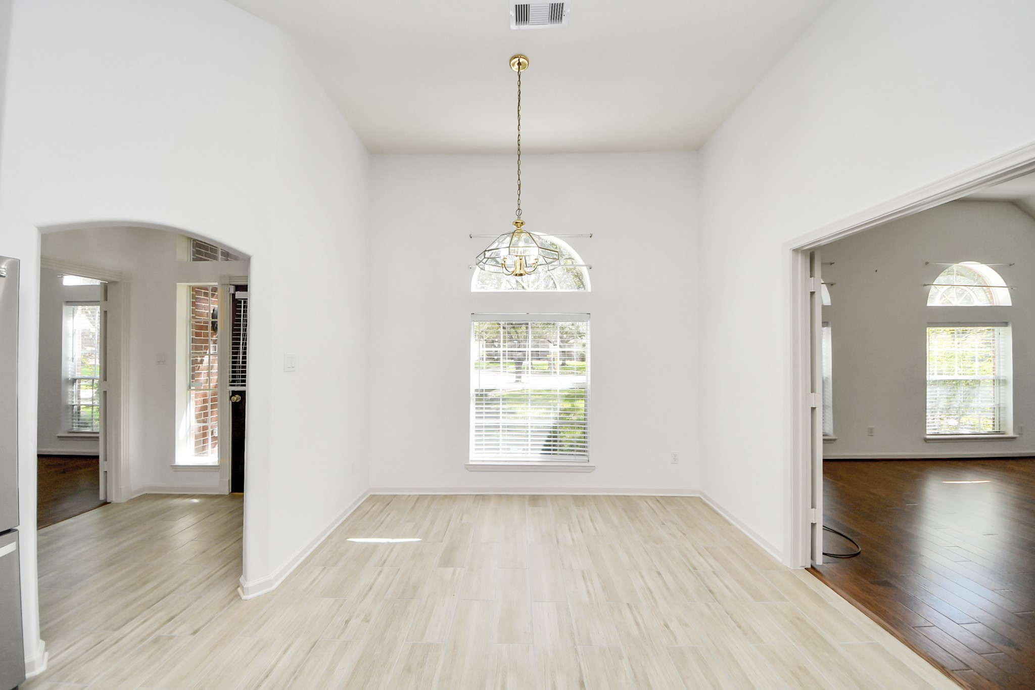 5815 Pheasant Ridge Lane Houston, TX 77041 - Photo 13 of 46 Bright and airy room with elegant light wood flooring, high ceilings, and large arched windows allowing abundant natural light.