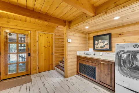 a open kitchen with granite countertop a sink dishwasher a stove and a refrigerator with wooden cabinets