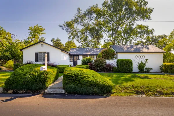 a front view of house with yard and green space