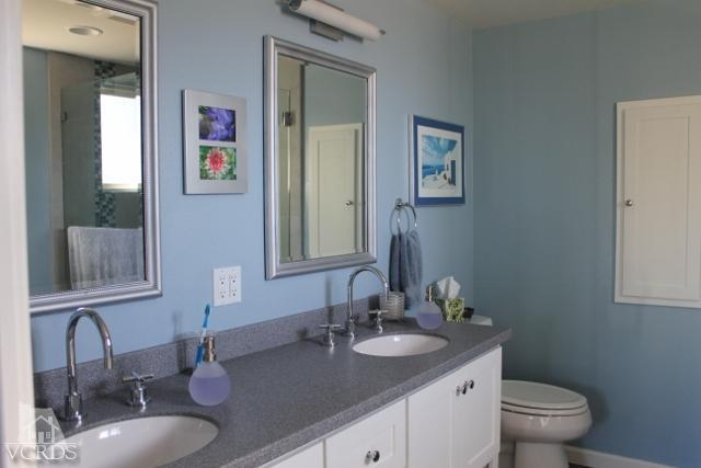 885 Erringer Road Simi Valley, CA 93065 - Photo 23 of 31 a bathroom with a granite countertop sink and a toilet
