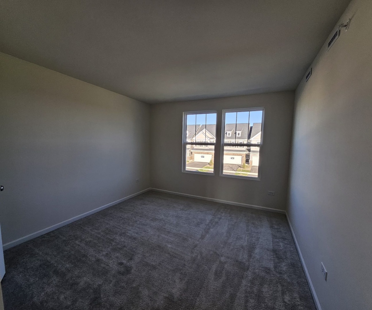 2212 Horseshoe Circle, Unit 2212 Plainfield, IL 60585 - Photo 3 of 12 an empty room with a window