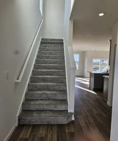 a view of entryway and hall with wooden floor
