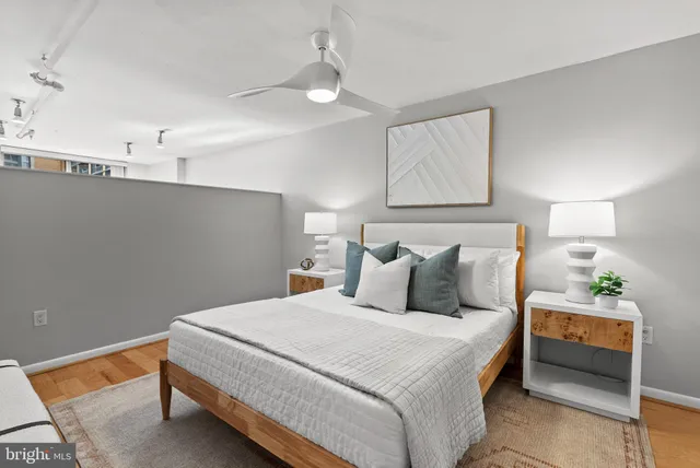 a bedroom with a bed and a painting on the wall