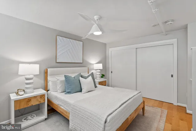 a bedroom with a bed and a night stand