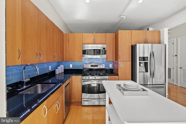 a kitchen with a refrigerator sink and stove