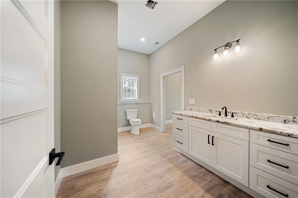 2956 Blalock Mountain Road Talking Rock, GA 30175 - Photo 31 of 65 a spacious bathroom with a granite countertop sink a toilet and a vanity
