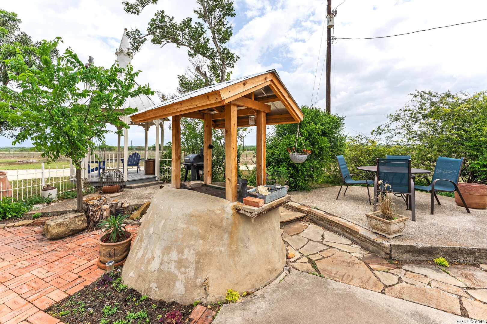4515 Stapper Road St. Hedwig, TX 78152 - Photo 38 of 64 a view of a patio with a table and chairs under an umbrella
