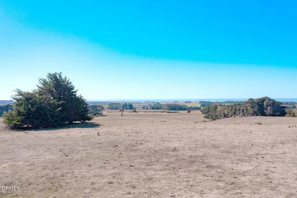 a view of a beach with a building in the background