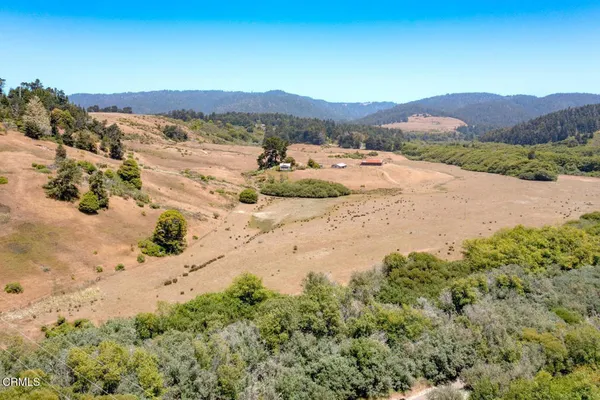 a view of a mountain with a lake in the background