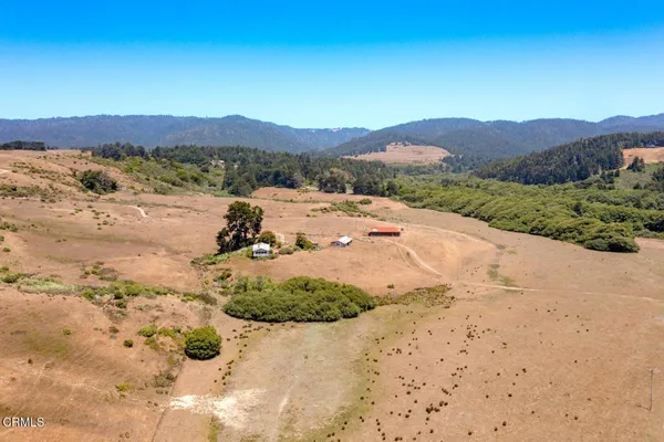view of a beach with a ocean view in back