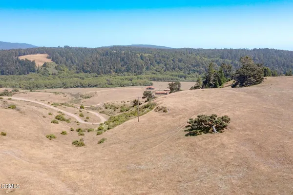 a view of a mountain with an ocean beach