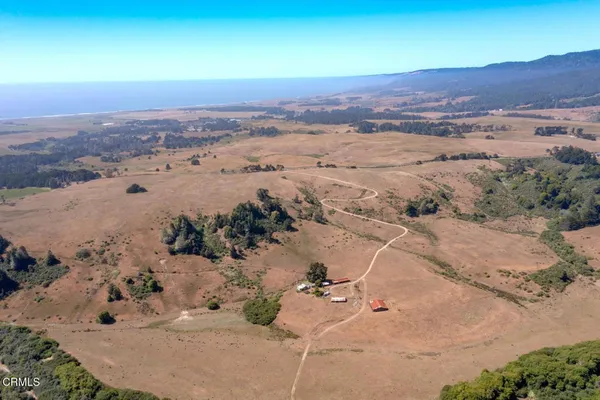 an aerial view of a houses with a yard
