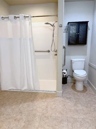 a bathroom with a toilet sink and shower