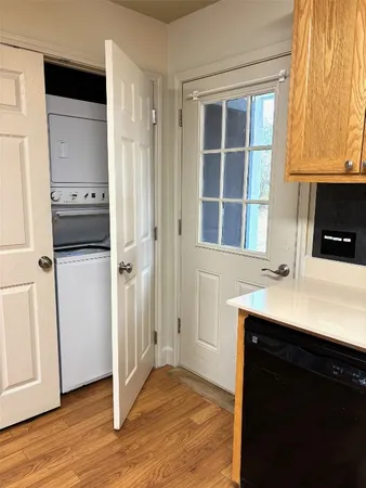 a kitchen with a sink cabinets stainless steel appliances and a window