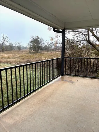 a view of balcony with yard