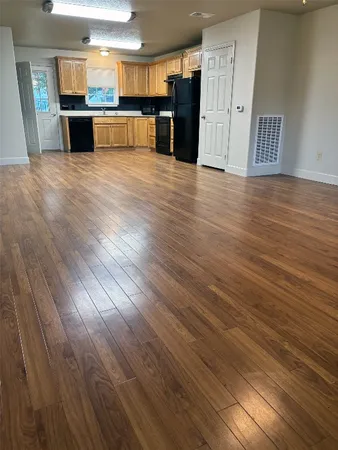 a view of a kitchen with a sink and a refrigerator