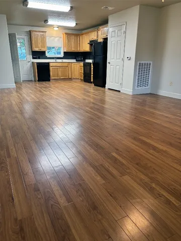 a view of a kitchen with a sink and a refrigerator