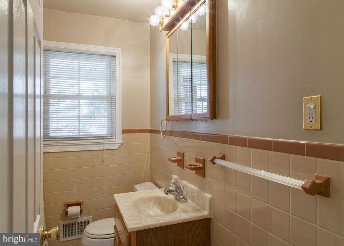 203 Bynum Ridge Road Forest Hill, MD 21050 - Photo 11 of 21 a bathroom with a sink a toilet and window