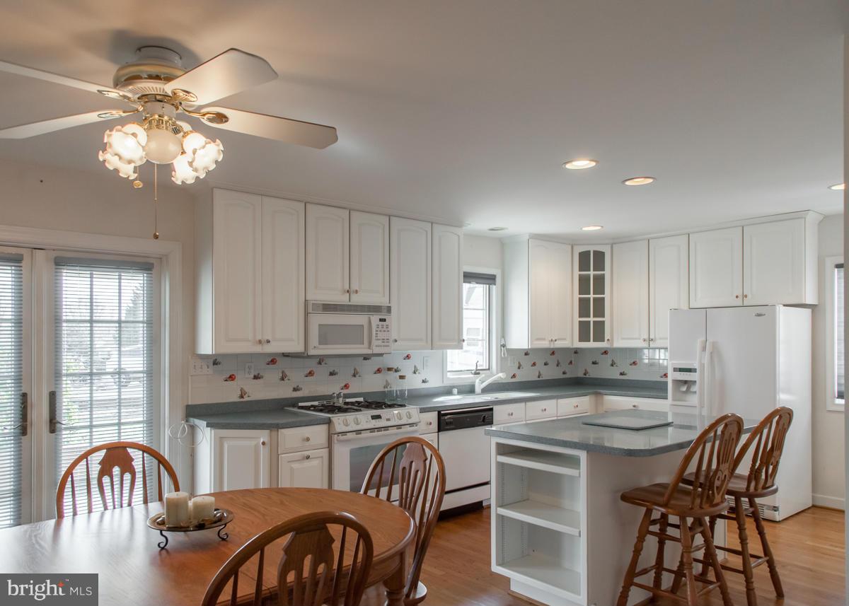 203 Bynum Ridge Road Forest Hill, MD 21050 - Photo 6 of 21 a kitchen with stainless steel appliances granite countertop a stove top oven a sink a dining table and chairs