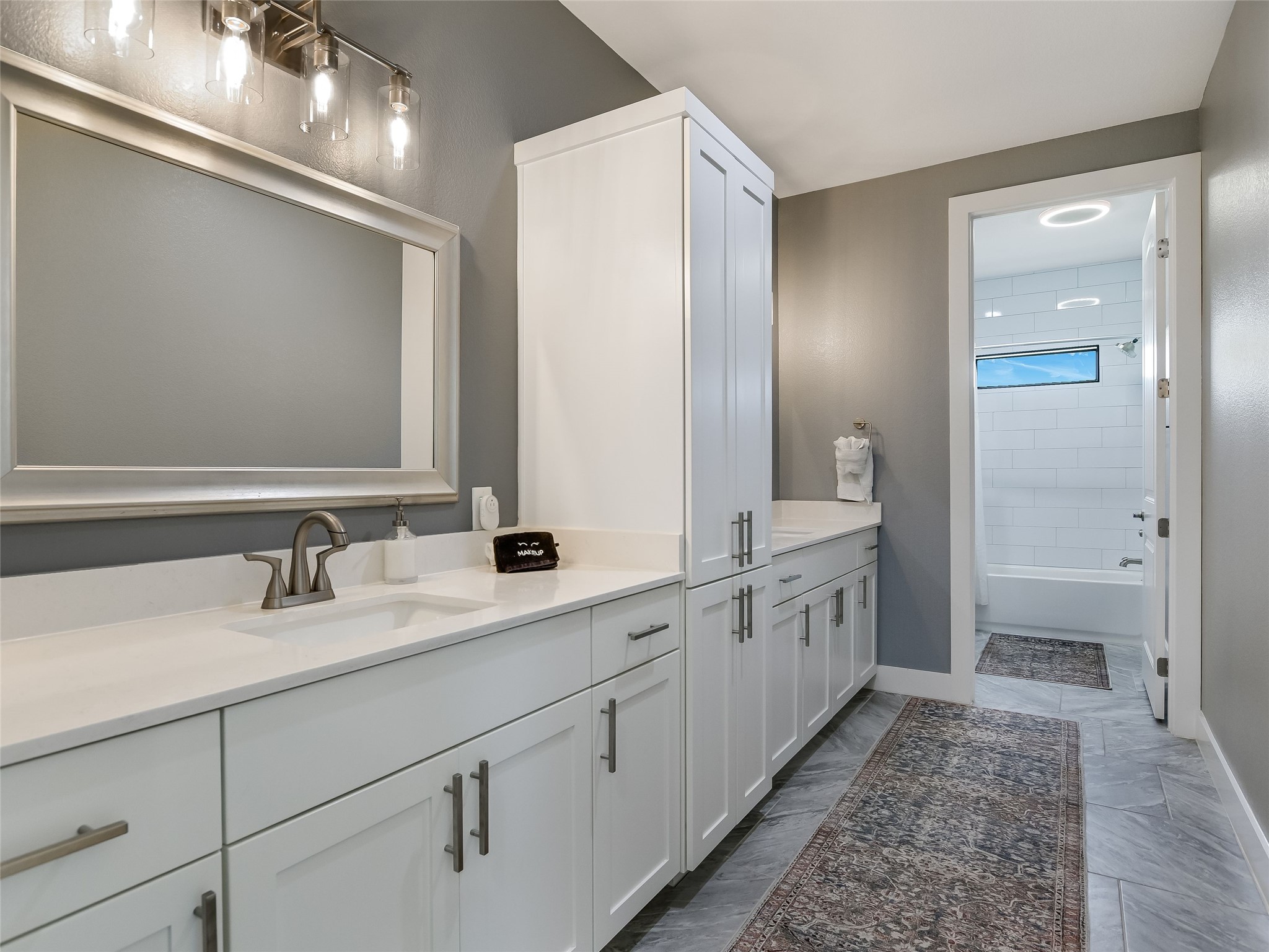 19819 Lockwood Road Manor, TX 78653 - Photo 15 of 29 The secondary bath is designed with daily life in mind—offering double vanities, extra storage, and a clean, modern aesthetic.