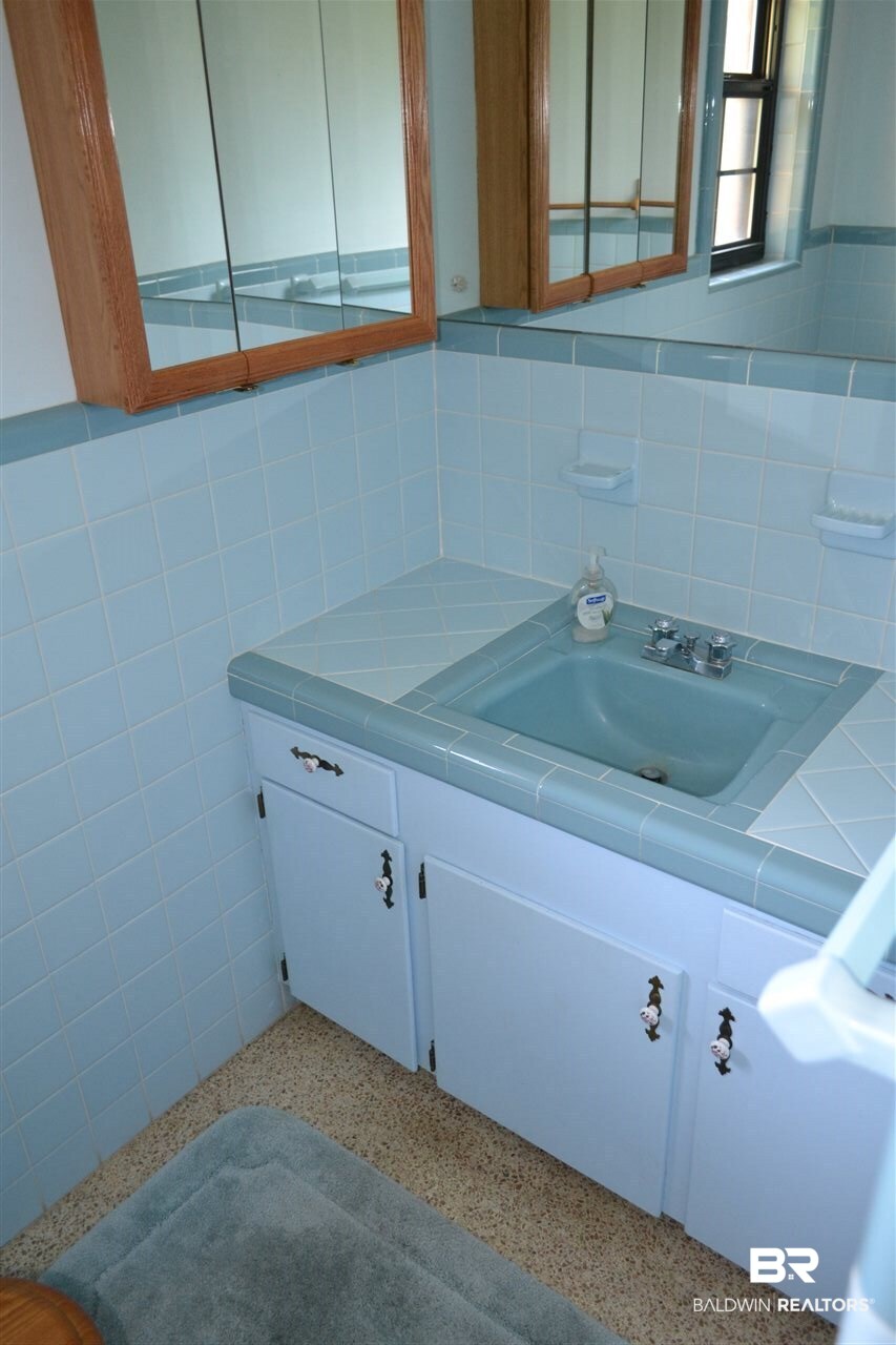 1525 North Alston Street Foley, AL 36535 - Photo 12 of 26 This bathroom serves Bedroom 2 and guests.