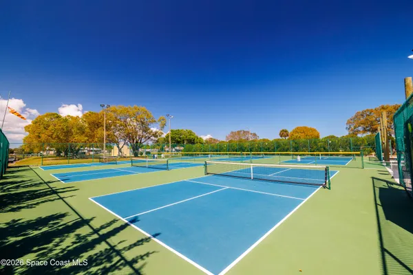 a room with pool table windows and wooden floor
