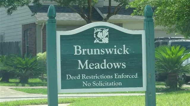a view of outdoor space with a garden and signage
