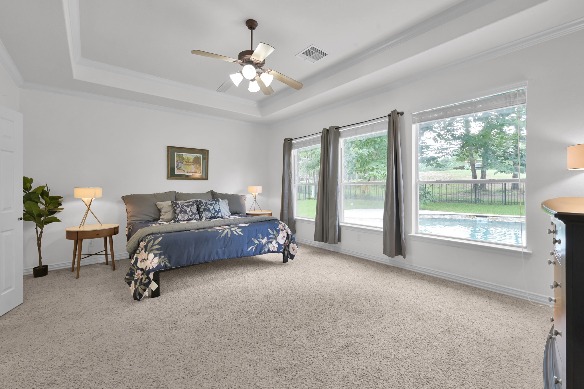 4770 Jackson Square Drive Conroe, TX 77304 - Photo 19 of 48 a spacious bedroom with a bed and a chandelier