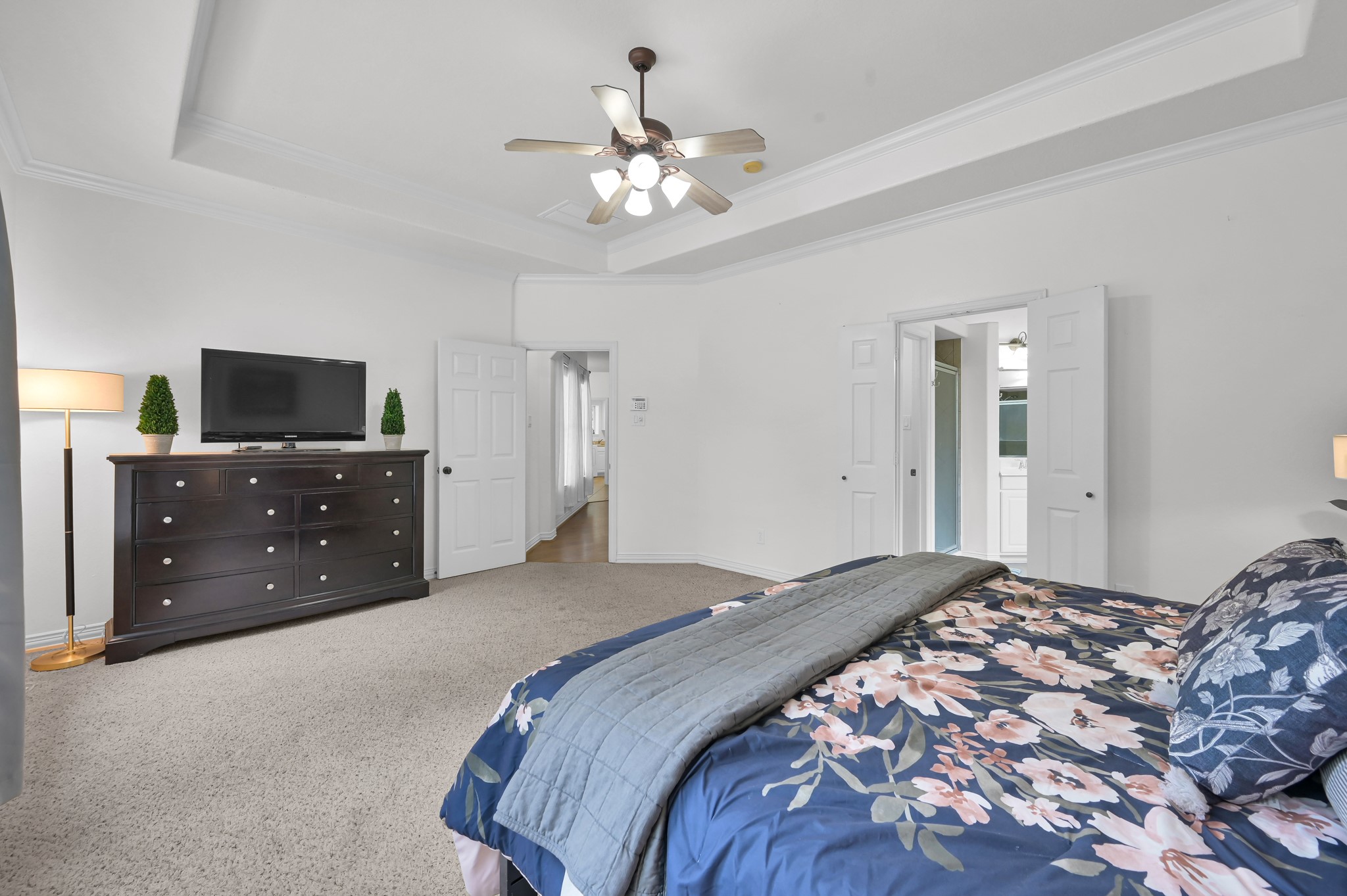 4770 Jackson Square Drive Conroe, TX 77304 - Photo 20 of 48 a bedroom with a bed and a flat tv screen on dresser