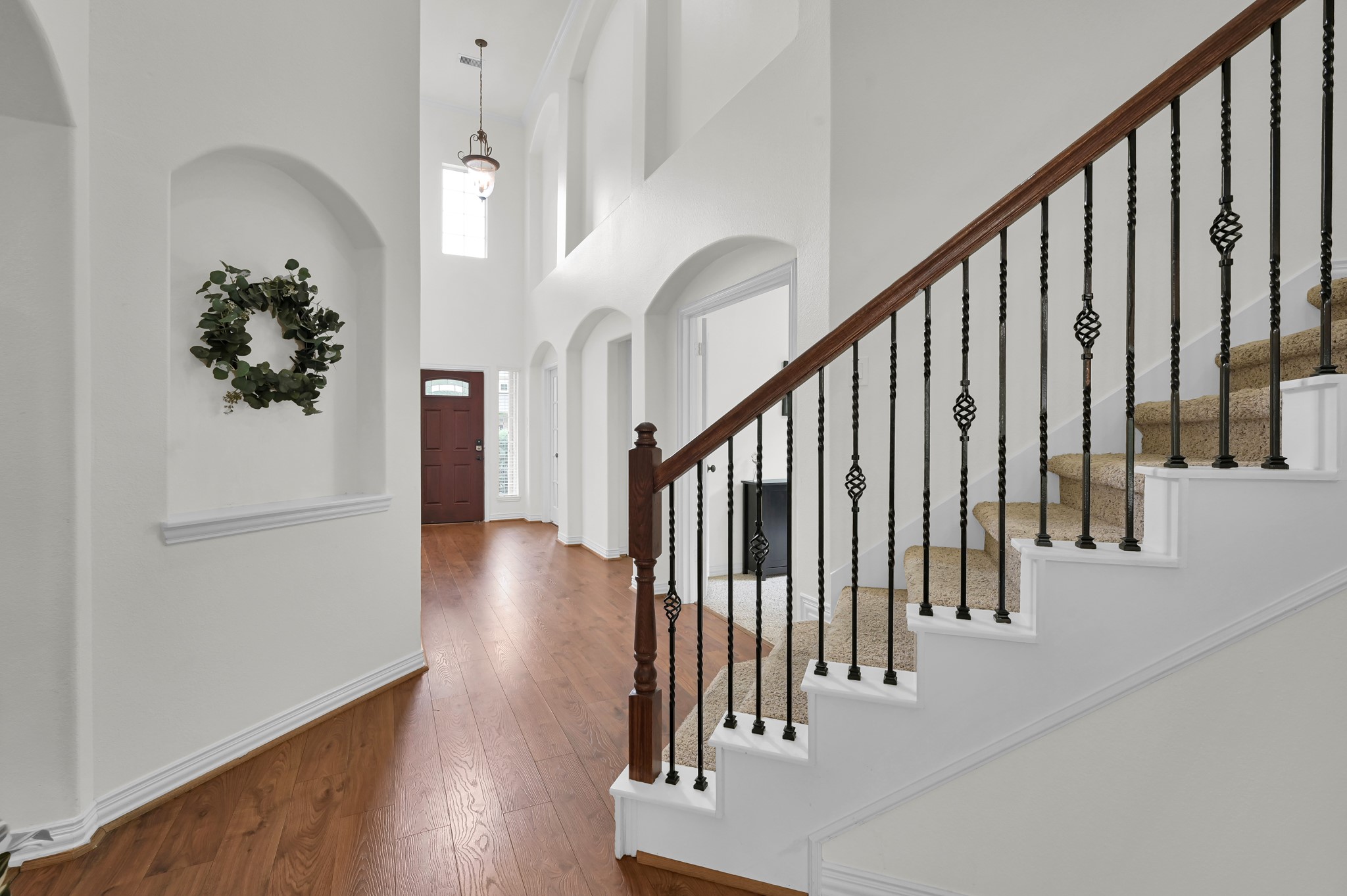 4770 Jackson Square Drive Conroe, TX 77304 - Photo 23 of 48 a view of staircase with lots of frames on wall and wooden floor