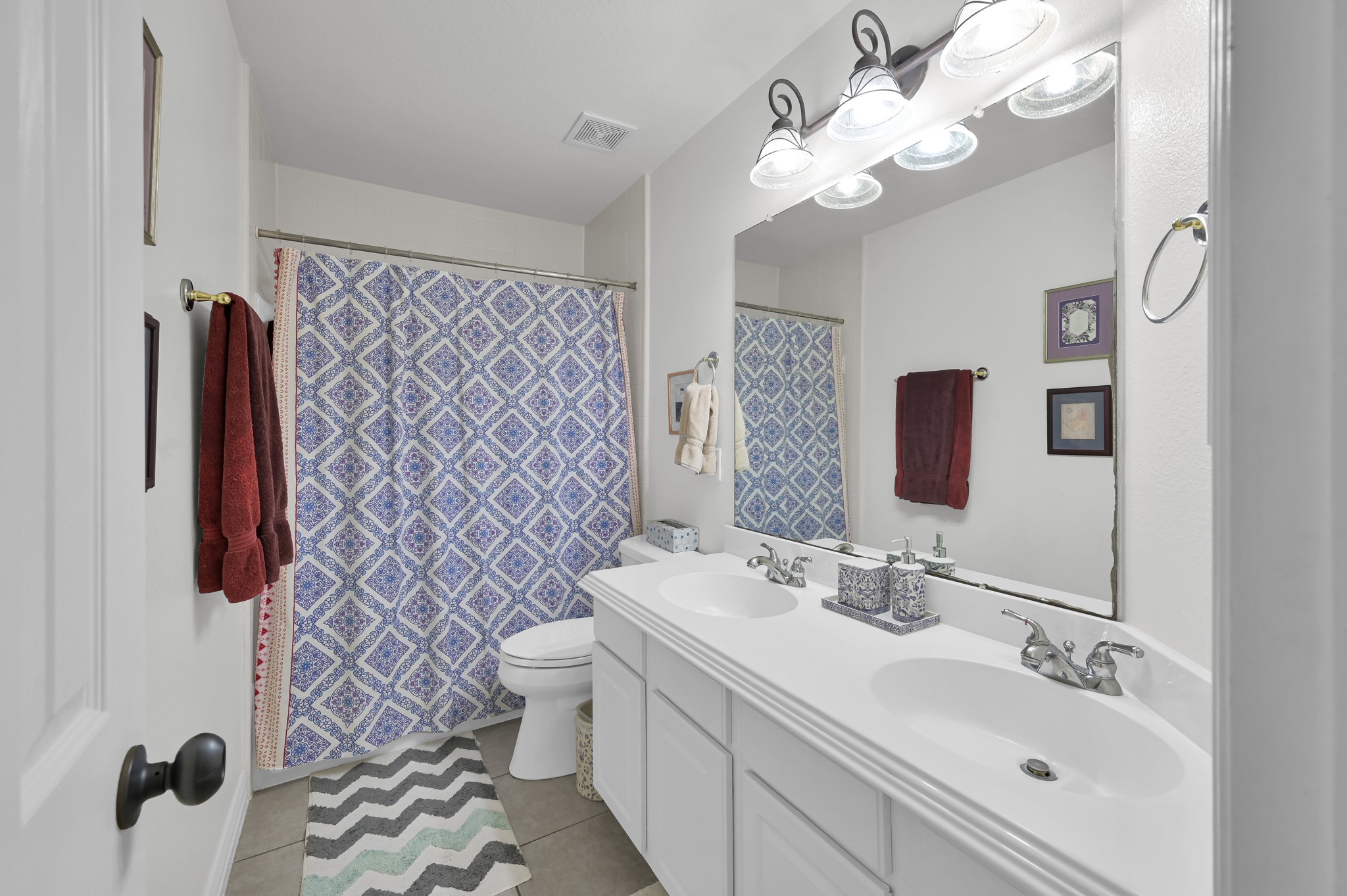 4770 Jackson Square Drive Conroe, TX 77304 - Photo 29 of 48 a bathroom with a sink a toilet and a mirror