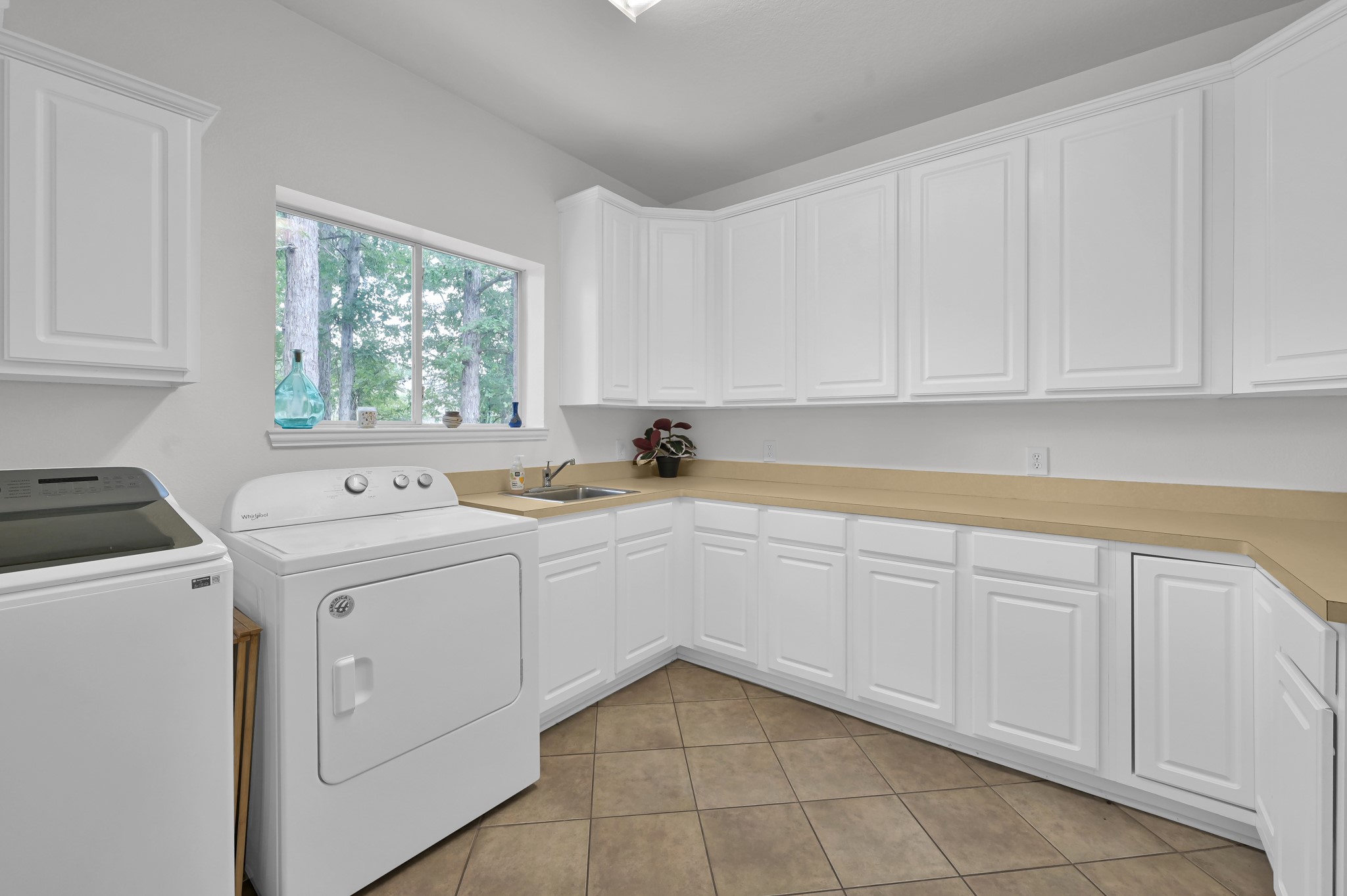 4770 Jackson Square Drive Conroe, TX 77304 - Photo 36 of 48 a utility room with cabinets washer and dryer