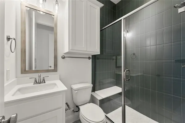 a bathroom with a sink toilet and shower