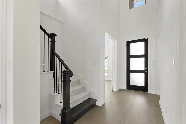 a view of an entryway with wooden floor