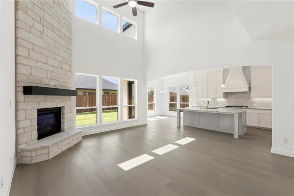 a large white kitchen with cabinets a sink and a stove