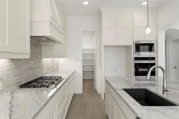 a kitchen with a sink stove and refrigerator